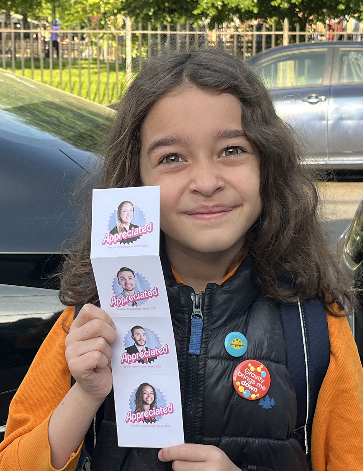 girl holds up stickers